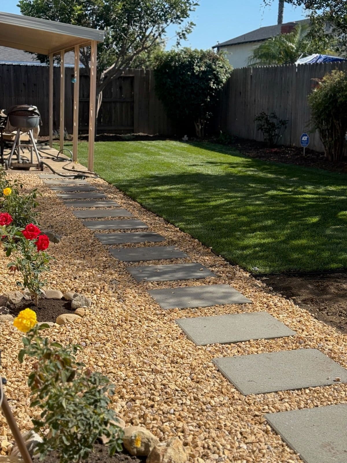 Lush Backyard with Stone Pathway and Artificial Turf image