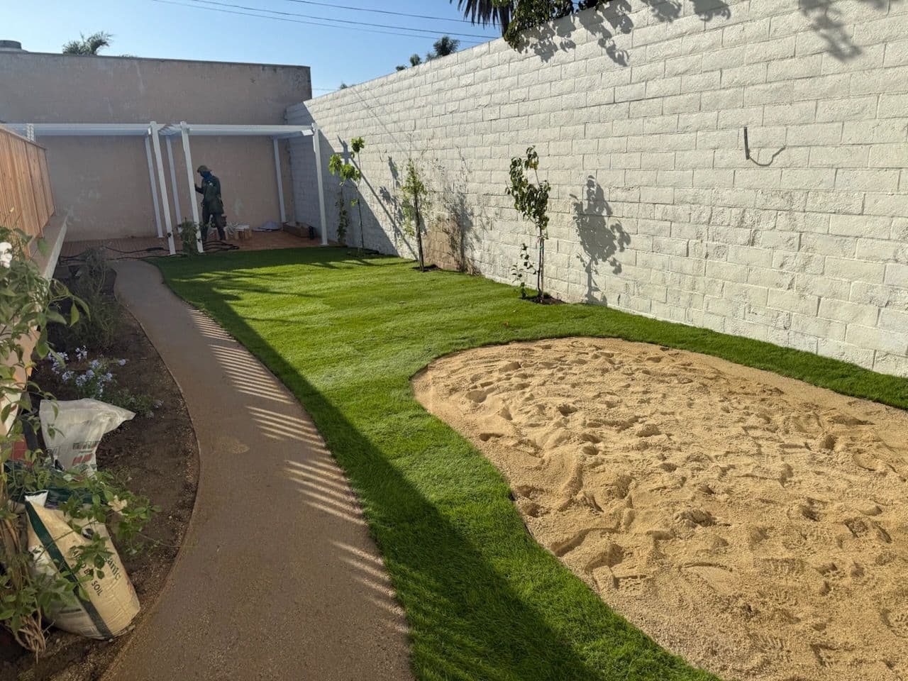 Backyard Makeover with Curved Paths and Cozy Pergola image